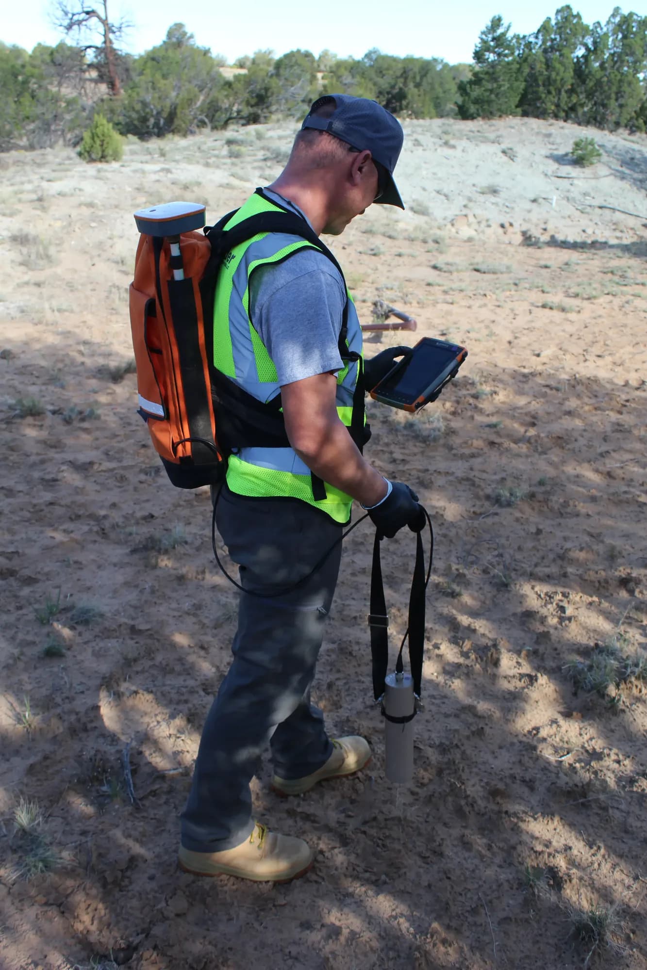 Field technician conducting GPS survey at Schmitt Decline Mine, Grants Mining District NM